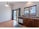 Bright kitchen features light wood cabinets, a dishwasher, and a sliding door leading to the backyard at 168 S 223Rd Dr, Buckeye, AZ 85326
