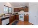 Functional kitchen with light wood cabinets, white appliances, and natural light, offering a practical cooking space at 168 S 223Rd Dr, Buckeye, AZ 85326