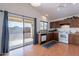 Traditional kitchen with wood cabinets, white appliances, and sliding glass door to the backyard at 168 S 223Rd Dr, Buckeye, AZ 85326