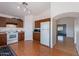 Open kitchen featuring white appliances, wood cabinets, and laminate countertops at 168 S 223Rd Dr, Buckeye, AZ 85326