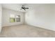 Bright and airy bedroom with large windows and neutral carpeting at 20121 N 76Th St # 2064, Scottsdale, AZ 85255