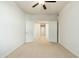 Bright bedroom with neutral carpet and double doors leading to a hallway with tile flooring at 20121 N 76Th St # 2064, Scottsdale, AZ 85255