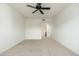 View of a simple bedroom with a ceiling fan and view of the attached bathroom at 20121 N 76Th St # 2064, Scottsdale, AZ 85255