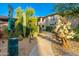 Modern condo with a landscaped walkway, desert foliage, and a convenient pet waste station at 20121 N 76Th St # 2064, Scottsdale, AZ 85255