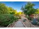 Beautifully landscaped grounds with lush trees and vibrant plants lead to a building entrance at 20121 N 76Th St # 2064, Scottsdale, AZ 85255