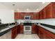 Bright kitchen featuring stainless steel appliances, tile floors, and sleek dark countertops at 20121 N 76Th St # 2064, Scottsdale, AZ 85255
