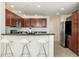 Kitchen features stainless steel appliances, dark wood cabinets, bar seating, and recessed lighting at 20121 N 76Th St # 2064, Scottsdale, AZ 85255