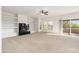 Spacious living room with a black tiled fireplace, built-in shelves, and a sliding glass door to a balcony at 20121 N 76Th St # 2064, Scottsdale, AZ 85255