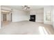 Neutral living room featuring a black fireplace, shelving and access to other rooms with carpeted floors at 20121 N 76Th St # 2064, Scottsdale, AZ 85255