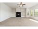 Bright, carpeted living room showcasing a modern fireplace and built-in shelving at 20121 N 76Th St # 2064, Scottsdale, AZ 85255