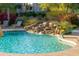 The community pool featuring a rock waterfall, providing a serene and inviting recreational space at 20121 N 76Th St # 2064, Scottsdale, AZ 85255