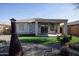 Beautiful outdoor living space with artificial turf, desert landscaping, a covered patio, and privacy fencing at 20222 N 267Th Ln, Buckeye, AZ 85396
