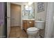 Bathroom with a light wood vanity, toilet, and a shower/tub combination with a curtain at 20222 N 267Th Ln, Buckeye, AZ 85396