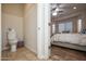 View of a bathroom showing a toilet and glimpse of a bedroom with wood-look tile at 20222 N 267Th Ln, Buckeye, AZ 85396