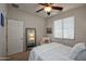 Comfortable bedroom with a plush queen bed, chair, ceiling fan and a window with natural light at 20222 N 267Th Ln, Buckeye, AZ 85396