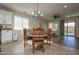 Dining room with light fixture, tile floor, and sliding glass door to backyard at 20222 N 267Th Ln, Buckeye, AZ 85396