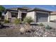 Charming single-story home with desert landscaping featuring rocks, agave, and a young palm tree at 20222 N 267Th Ln, Buckeye, AZ 85396