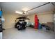 Large garage with painted floor, storage shelves, a golf cart, and ample room for parking and projects at 20222 N 267Th Ln, Buckeye, AZ 85396