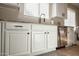 Bright kitchen with white cabinetry, granite countertops, and stainless steel dishwasher at 20222 N 267Th Ln, Buckeye, AZ 85396