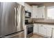 Modern kitchen features stainless steel appliances and white cabinets at 20222 N 267Th Ln, Buckeye, AZ 85396