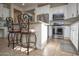 Bright white kitchen featuring stainless steel appliances and counter seating at the breakfast bar at 20222 N 267Th Ln, Buckeye, AZ 85396