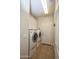 Well-lit laundry room featuring a washer and dryer, tiled floors, and white cabinets for storage at 20222 N 267Th Ln, Buckeye, AZ 85396
