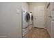 Functional laundry room with modern washer and dryer units on a tiled floor at 20222 N 267Th Ln, Buckeye, AZ 85396