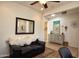 Comfortable living room features a decorative mirror and adjacent entryway at 20222 N 267Th Ln, Buckeye, AZ 85396