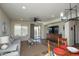 Open floor plan showing living room with ceiling fan, dining room, and sliding glass door at 20222 N 267Th Ln, Buckeye, AZ 85396