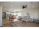 Open floor plan showcasing living room with dining area, kitchen, and modern furniture at 20222 N 267Th Ln, Buckeye, AZ 85396