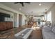Open floor plan showcasing living room with dining area, kitchen, and modern furniture at 20222 N 267Th Ln, Buckeye, AZ 85396