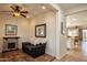 Inviting living room with stone fireplace, ceiling fan, and bright natural light at 20222 N 267Th Ln, Buckeye, AZ 85396