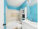 Turquoise bathroom featuring a shower-tub combo, large mirror, and tile flooring at 2049 W Joan De Arc Ave, Phoenix, AZ 85029