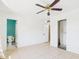 Spacious bedroom with tile floors, closet space, and access to an ensuite bathroom at 2049 W Joan De Arc Ave, Phoenix, AZ 85029