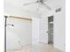 Bright bedroom featuring tile floors, a closet, and a ceiling fan at 2049 W Joan De Arc Ave, Phoenix, AZ 85029