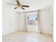 Bright bedroom with a ceiling fan, tile floors, and a large window with curtains at 2049 W Joan De Arc Ave, Phoenix, AZ 85029