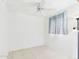 Clean and simple bedroom with white walls, tile floors, and a ceiling fan at 2049 W Joan De Arc Ave, Phoenix, AZ 85029