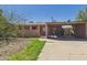 View of a house featuring a carport and desert landscaping with gravel and sparse grass at 2049 W Joan De Arc Ave, Phoenix, AZ 85029