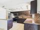 Updated kitchen features stainless appliances, ample dark wood cabinetry, and tile backsplash at 2049 W Joan De Arc Ave, Phoenix, AZ 85029