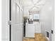 Convenient laundry room featuring washer, dryer, overhead cabinet, and ceiling fan at 2049 W Joan De Arc Ave, Phoenix, AZ 85029