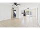 Spacious living room with tile flooring, bright white walls, and view of the updated kitchen at 2049 W Joan De Arc Ave, Phoenix, AZ 85029