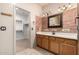 Unique bathroom boasts a beautiful brick wall, oak cabinets, and walk-in closet at 2101 S Meridian Rd # 26, Apache Junction, AZ 85120