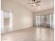 Bedroom with a ceiling fan, neutral walls, tiled floors, and ample natural light at 2101 S Meridian Rd # 26, Apache Junction, AZ 85120