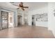 Bright living room featuring neutral paint, tile floors, a ceiling fan, and a sliding glass door at 2101 S Meridian Rd # 26, Apache Junction, AZ 85120