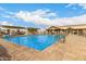 Relaxing community pool with lounge chairs and a covered patio for shade on a sunny day at 2101 S Meridian Rd # 26, Apache Junction, AZ 85120