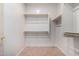 A clean walk-in closet provides ample storage space with wooden shelving at 2101 S Meridian Rd # 26, Apache Junction, AZ 85120