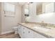 Bathroom featuring double vanity with granite countertops and a well-lit mirror at 21313 N 59Th Dr, Glendale, AZ 85308