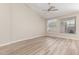 Bright bedroom with wood-look floors, fan and windows with blinds at 21313 N 59Th Dr, Glendale, AZ 85308