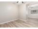 Bright empty room featuring wood-style flooring, neutral walls, and recessed lighting at 21313 N 59Th Dr, Glendale, AZ 85308
