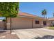 Single-Gathering home with attached two-car garage, concrete driveway, and desert landscaping at 21313 N 59Th Dr, Glendale, AZ 85308